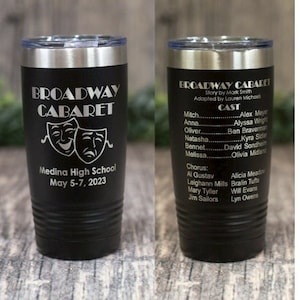 May include: Black stainless steel tumbler with a white engraved design. The design features the words "Broadway Cabaret" with two theatrical masks and the text "Medina High School May 5-7, 2023".