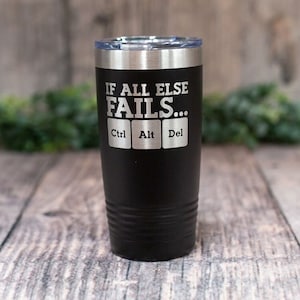 May include: Black stainless steel tumbler with a white inscription that reads "If all else fails... Ctrl Alt Del".