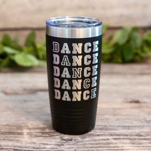 May include: Black stainless steel tumbler with a silver inscription that reads "DANCE" repeated five times.