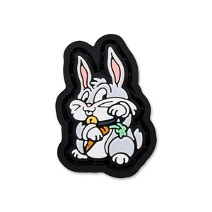 May include: A cartoon image of a gray rabbit holding a carrot and a green vegetable, set against a black background. The rabbit has pink inner ears and is smiling. The image is a cartoon character.