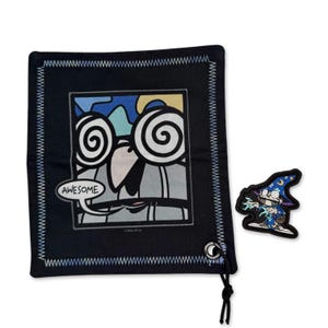 May include: Black drawstring bag with a stitched border and a cartoon graphic that says "AWESOME". Includes a matching patch of a wizard character. The bag has a black drawstring and a white stitched border.