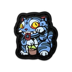 May include: A cartoon-style patch featuring a blue cat with yellow eyes, a red tongue, and a small brown pot with green plants. The cat is outlined in black and has a black border.