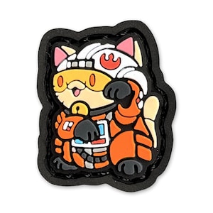 May include: A cartoon cat wearing an orange and white space suit with a rebel alliance symbol on the helmet. The cat is wearing a yellow visor and has a white tail. The cat is standing on a black background.