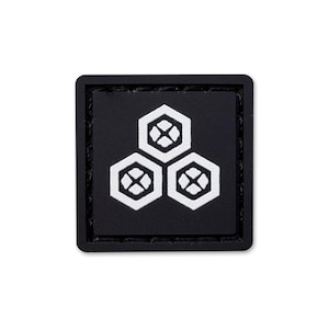 May include: A square black patch featuring a white graphic design of three interconnected hexagons. Each hexagon contains a smaller four-petaled floral motif in the centre. The patch has a thick black border and stitched edges.