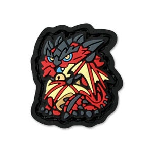 May include: A colorful dragon-themed charm with a black border. The dragon features red, yellow, and gray details, including wings and a fierce expression. The charm is designed with a 3D effect, giving it a textured appearance.