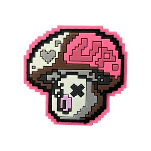 May include: A pixelated mushroom-shaped charm with a pink outline. The mushroom cap is divided into sections of white, brown, and pink, with a heart and the letters "LP" visible. The mushroom's face has an "X" for eyes and a pink tongue.