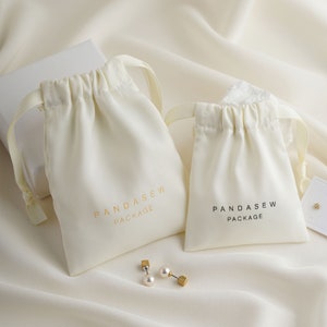beige/cream color dense thick satin bag, luxury cloth bag