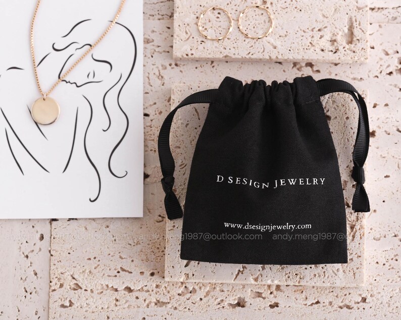 black 8 oz cotton canvas jewelry pouch with white logo