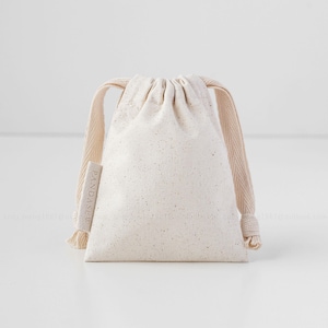 beige cotton drawstring bag with label