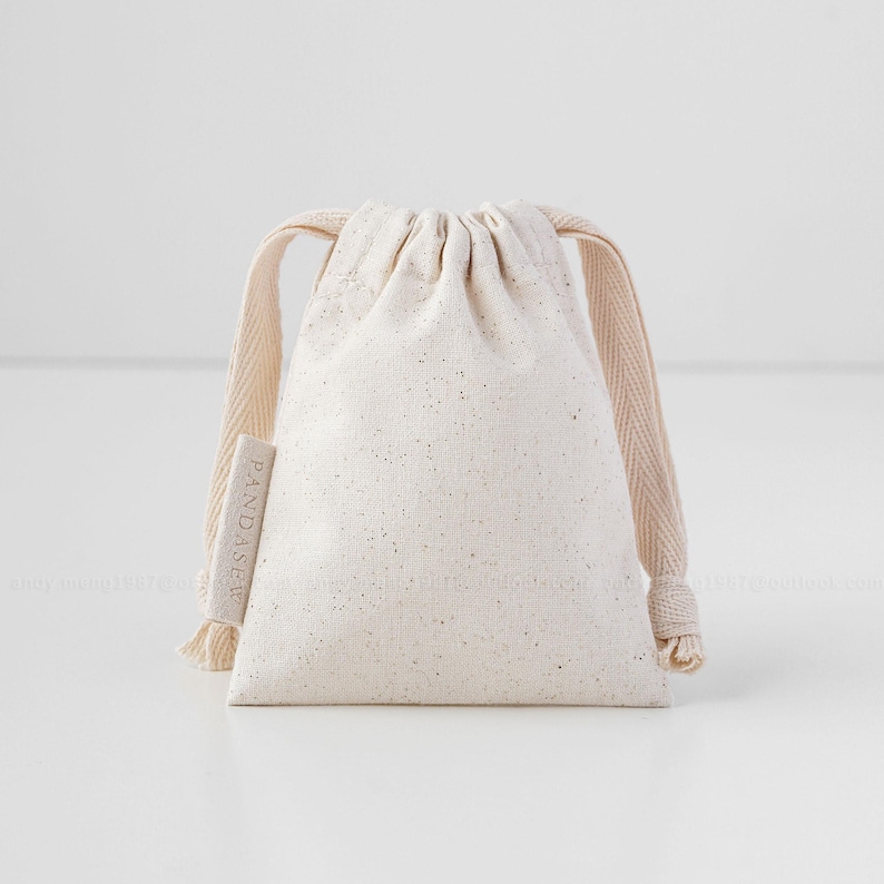 beige cotton drawstring bag with label