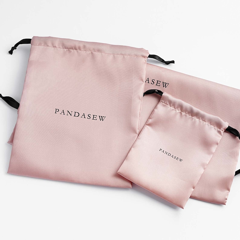 pink color satin bag with black satin ribbon and black logo, custom dust bag