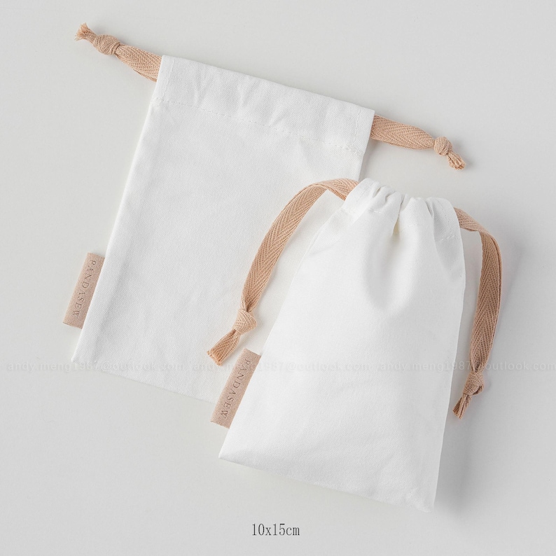 white canvas drawstring bag with label