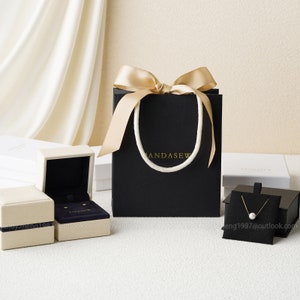 black paper bags with gold handles