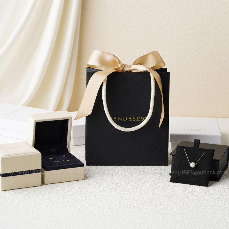 black paper bags with gold handles