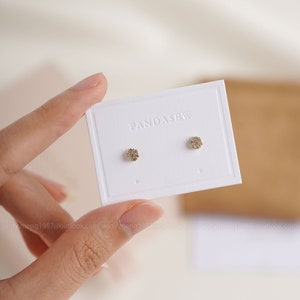 small earring card with colorless debossed logo