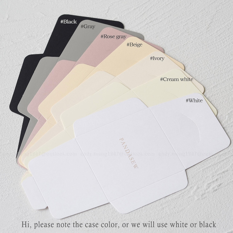 May include: A selection of small, folded boxes in various colors, including black, gray, rose gray, beige, ivory, cream white, and white. The boxes are labeled with their corresponding color names. The text "PANDASEW" is printed on the bottom box.