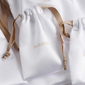 white satin bag with khaki ribbon, pantone 726C beige logo