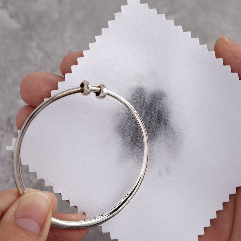 Asilver bracelet was cleaned by treated cloth