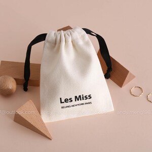 beige 12 oz cotton canvas bag with logo and ribbon, products dusty bag