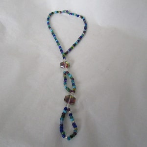 May include: A blue, green, and purple beaded foot chain with three iridescent crystal accents.