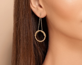 Mira rim earings - Dangling beaded circle earring in 14 karat yellow solid gold displaying shiny diamond cut ball beads on a dainty