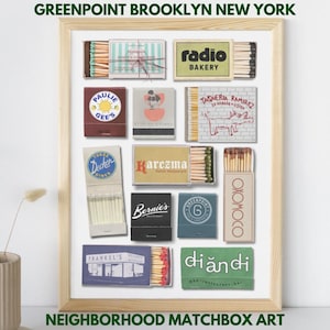 May include: A framed print featuring a collection of matchboxes from Greenpoint, Brooklyn. The matchboxes display various restaurant and business names, including "Radio Bakery" and "Paulie Gee's." The text "Neighborhood Matchbox Art" is at the bottom.