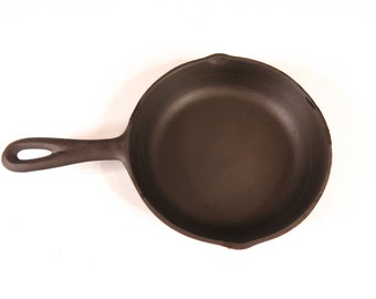 May include: A cast iron skillet with a black handle. The skillet is empty and ready to be used for cooking.