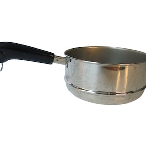 May include: A stainless steel saucepan with a black plastic handle. The saucepan has a small ring on the handle and a strainer insert.