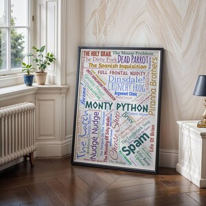 May include: A framed poster with a black border, displaying a word cloud of Monty Python-related phrases. The words, in various colours and fonts, are set against a white background. The poster is displayed in a room with a window and potted plants.