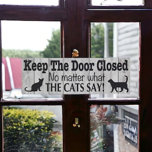 Keep The Door Closed No Matter What The Cats Say Sign