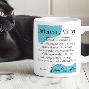 May include: White ceramic mug with a blue and white design. The mug features the text "Difference Maker" with a definition and the name "Liam Winston".