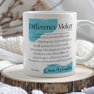 May include: White ceramic coffee mug with a blue and white design. The mug features the text "Difference Maker" with a definition and the name "Liam Winston".