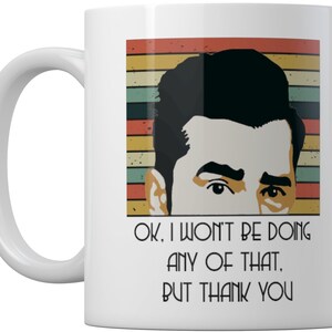 May include: White ceramic mug featuring a retro-style illustration of a man with a serious expression. The text on the mug reads "Ok, I won't be doing any of that. But thank you."