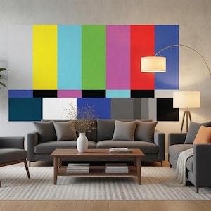 May include: A modern living room with a large, colorful abstract art piece on the wall. The artwork features vertical bands of yellow, green, purple, red, and blue. The room includes a gray sofa, armchair, wooden coffee table, and a floor lamp.