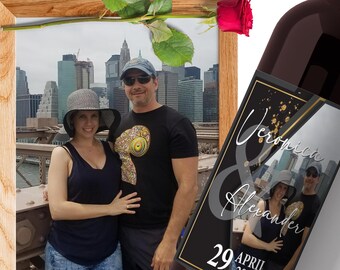 May include: A black and gold wine bottle label with the text "Veronica & Alexander" and the date "29 April". The label features a photo of a couple in front of a city skyline.