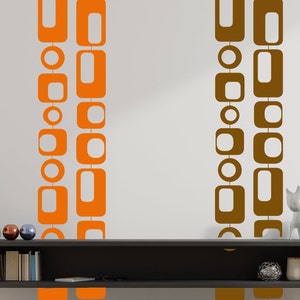 May include: Two vertical rows of geometric shapes, one in orange and one in brown, are on a white wall. The shapes are circles and squares, and they are connected by lines. The shapes are in a modern style.