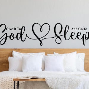 May include: A bedroom wall decal with the text "Give it to God and go to sleep" with a heart in the middle of the text.