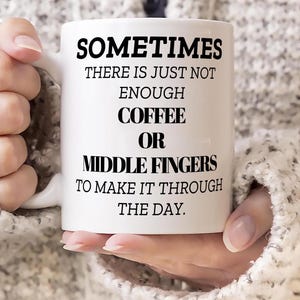 Puede incluir: Taza de café de cerámica blanca con texto negro que dice "A veces no hay suficiente café o dedos medios para pasar el día."