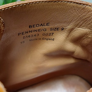 May include: Close-up of the inside of a brown leather shoe with the text "BEDALE PENNINE/G SIZE 9 514343 0027 15 Made in England" printed on the insole.