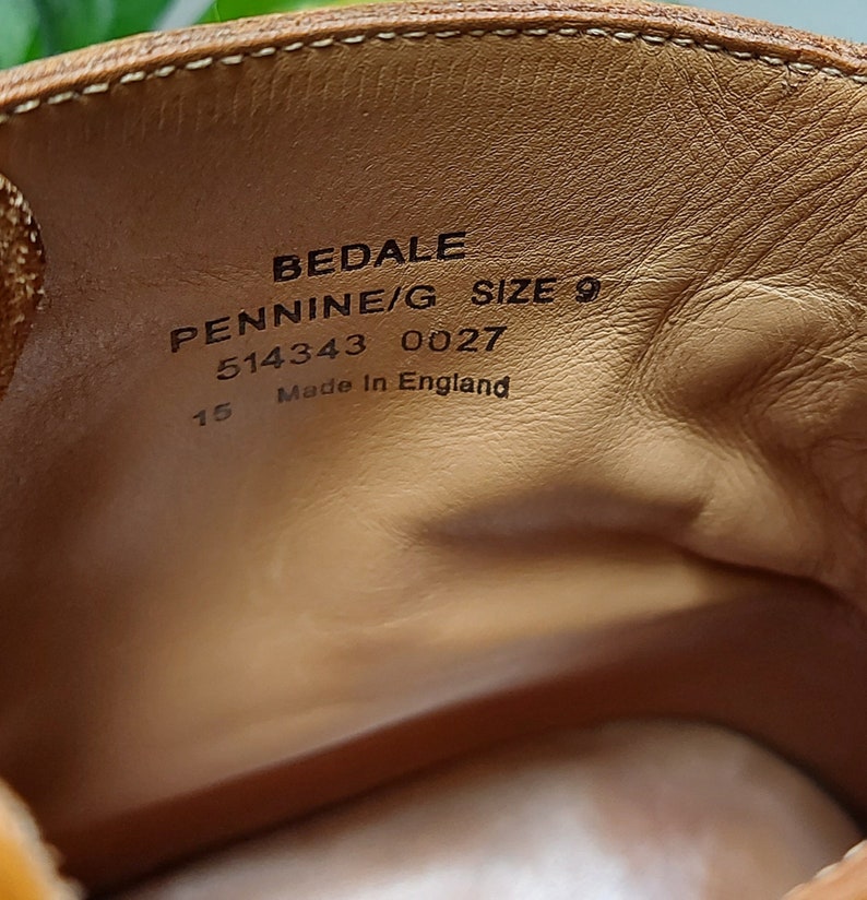 May include: Close-up of the inside of a brown leather shoe with the text "BEDALE PENNINE/G SIZE 9 514343 0027 15 Made in England" printed on the insole.