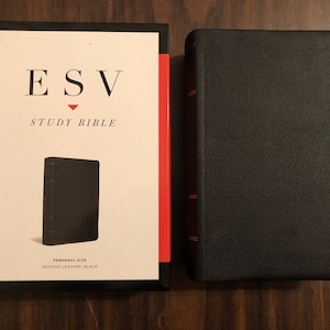 May include: A black leather-bound ESV Study Bible with the title "ESV Study Bible" printed on the front cover. The cover also includes the text "Personal Size" and "Genuine Leather, Black".