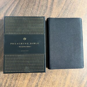 May include: A black leather-bound Bible with gold lettering on the cover. The cover reads "Preaching Bible - Verse-by-Verse Edition - Goatskin, Black".