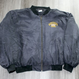 May include: A dark blue bomber jacket with a black zipper and black ribbed cuffs. The jacket has a yellow embroidered logo that says "Dangerous" with a motorcycle graphic.