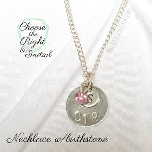 May include: Silver necklace with a round charm featuring the letters "CTR" and the initial "S". A pink birthstone is attached to the charm. The necklace is on a white background with the text "Choose the Right & Initial" and "Necklace w/birthstone".