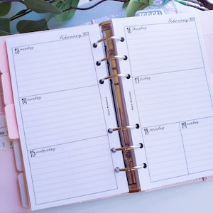 May include: A weekly planner with a white background and black text. The planner is open to February 2023, showing the days from Wednesday the 13th to Sunday the 19th. The planner has a silver ring binder.