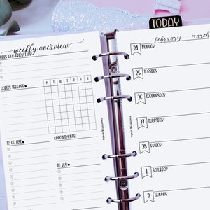 May include: A weekly planner with a black and white design. The planner has a section for goals and priorities, a to-do list, appointments, and gratitudes. The planner also has a calendar section for the month of February and March 2025.