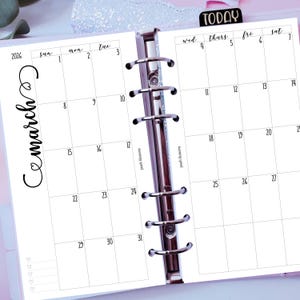 May include: A white planner insert for March 2026, with a calendar layout showing dates and days of the week. The word "Cemarch" is written in cursive. The word "TODAY" is on a black tab.