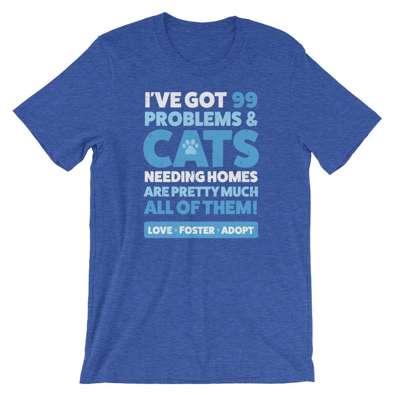 Puede incluir: Camiseta azul con un gr&aacute;fico blanco que dice "Tengo 99 problemas & gatos que necesitan hogar, son casi todos! Amar, acoger, adoptar"