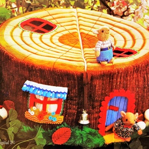 May include: A plush toy tree trunk house with a blue door, a red window, and a bell. Two small plush mice are standing in front of the house. The tree trunk is brown and has a yellow top with rings. The house is surrounded by green leaves and flowers.