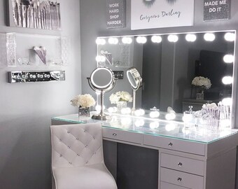 black vanity with mirror and lights